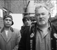 Watch Stewart Lee front Asian Dub Foundation for ‘Comin’ Over Here’ video
