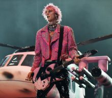 Machine Gun Kelly zip-lines across stadium, smashes glass on his own face at hometown show in Cleveland